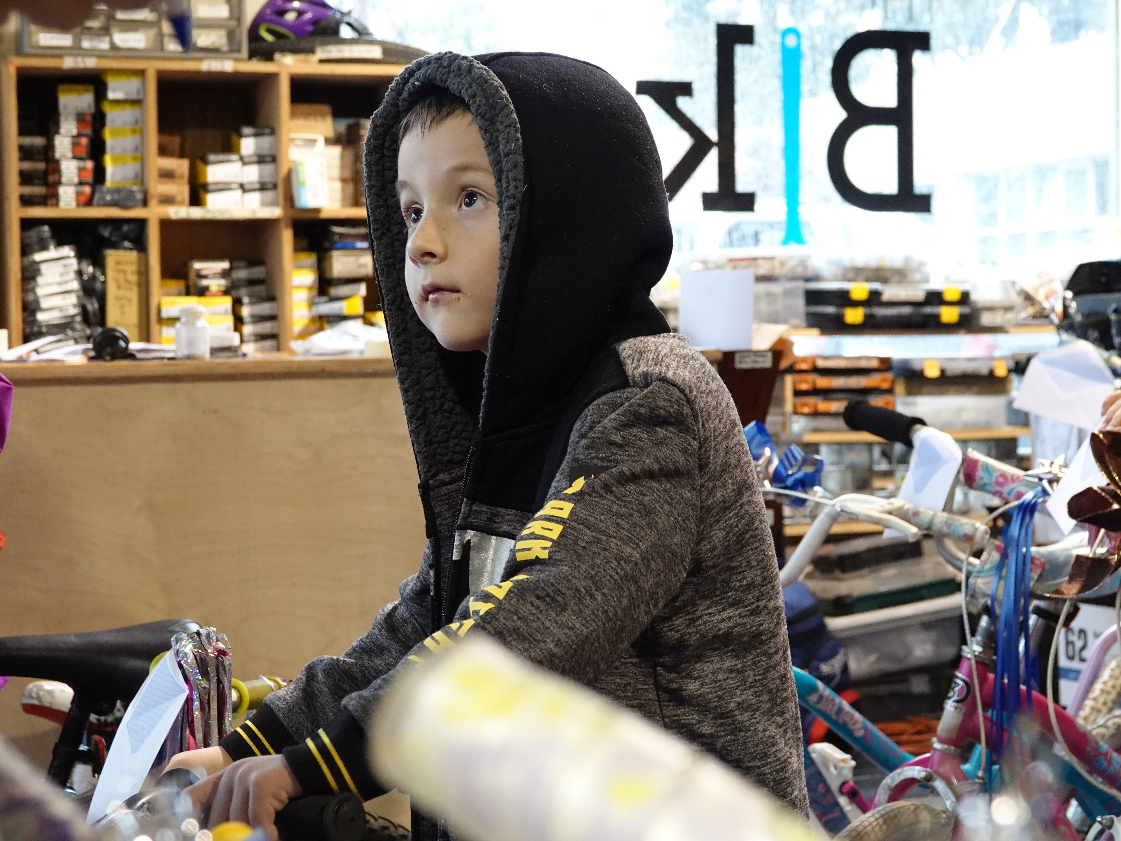 Roman Gonzalez tries out a bike Sunday before a holiday giveaway at Ventura Bike HUB. The nonprofit shop fixed up about 30 bicycles to give to local children in need.