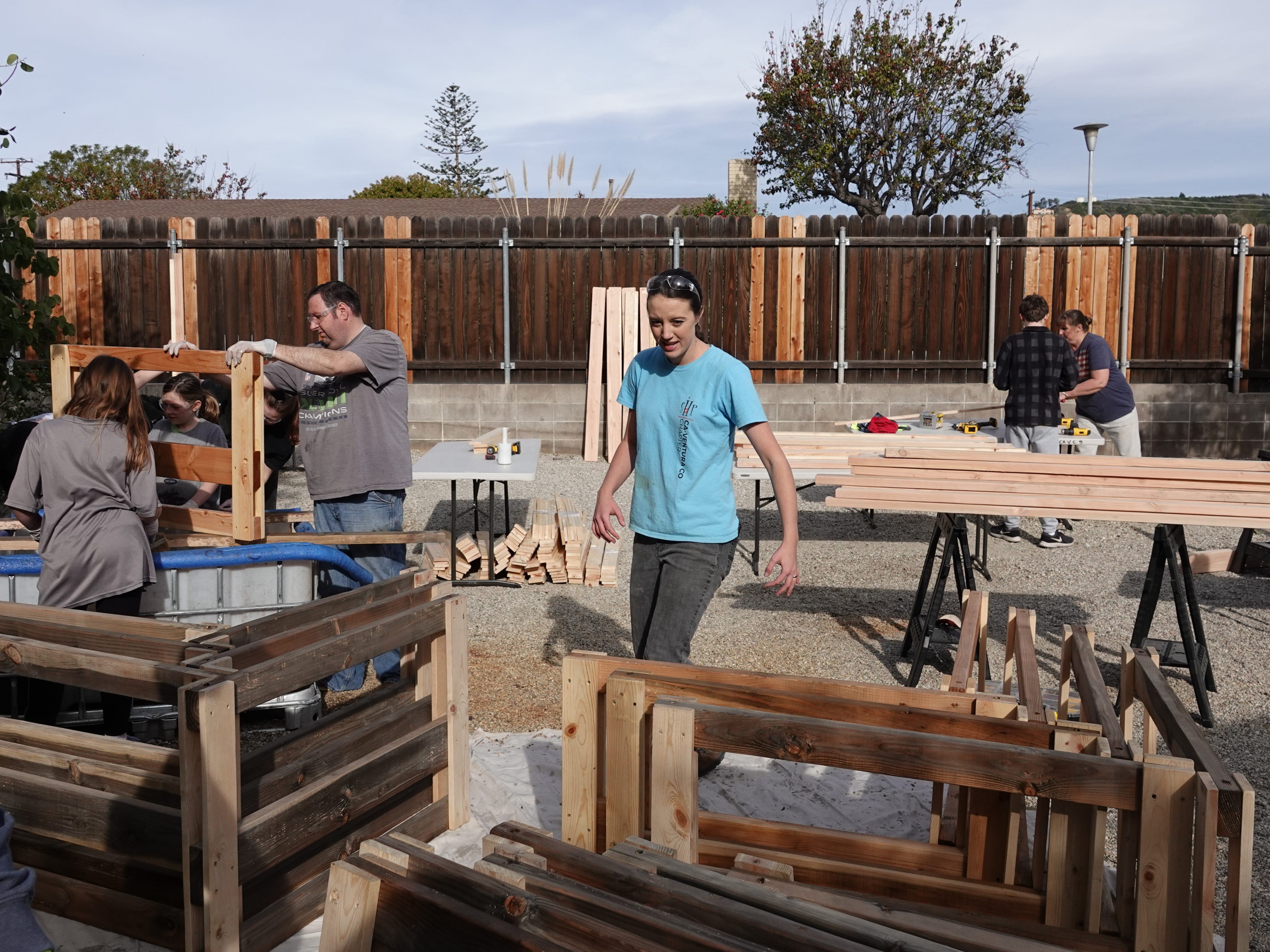 Camarillo resident Marissa Bradley, center, oversees construction of 14 bunk beds Saturday that will be donated to children in need. Bradley heads the local chapter of nonprofit Sleep in Heavenly Peace.