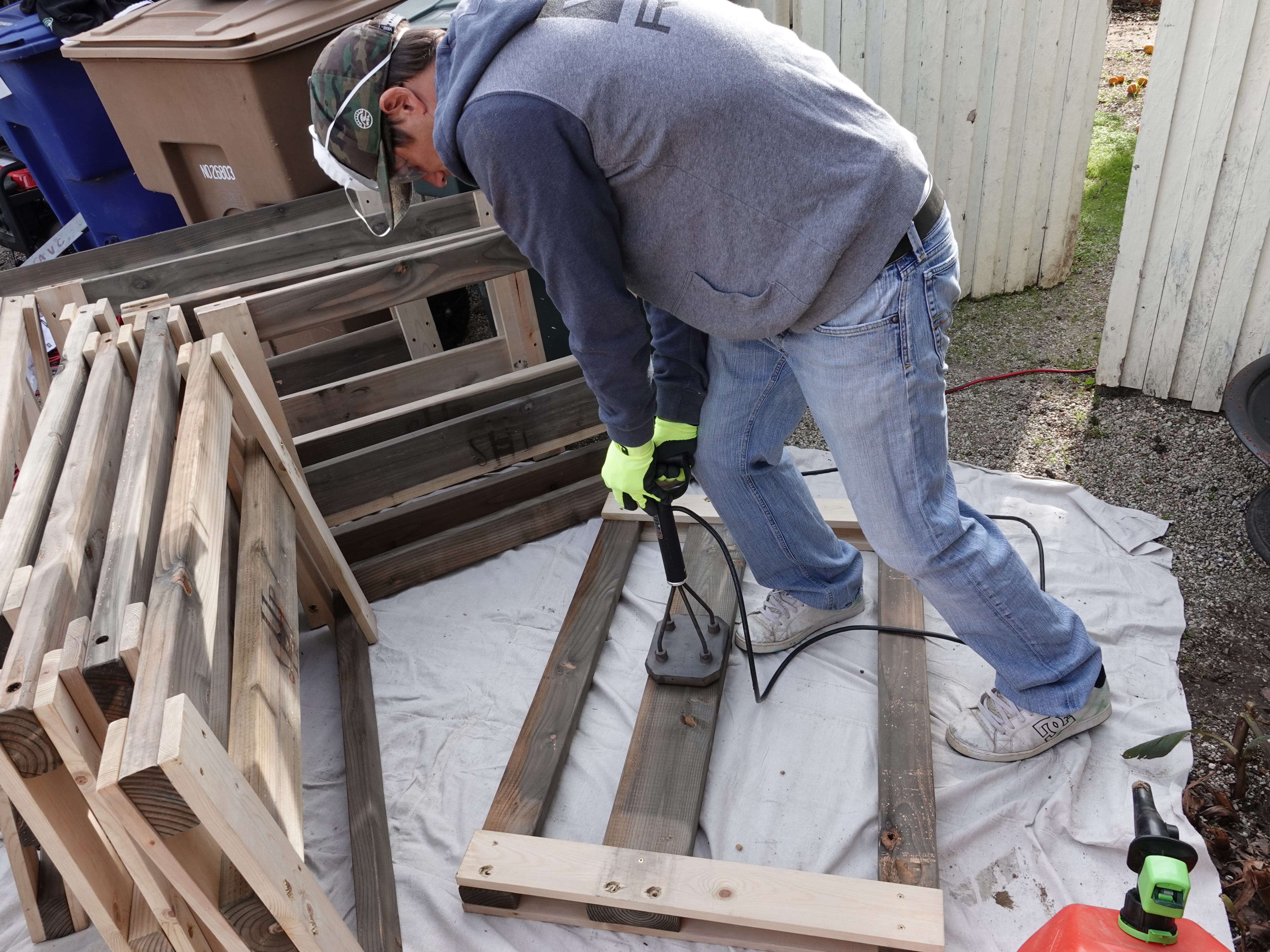 Gordon Hachtman brands a headboard with the initials of a nonprofit Saturday in Camarillo when volunteers built 14 beds for local children in need.