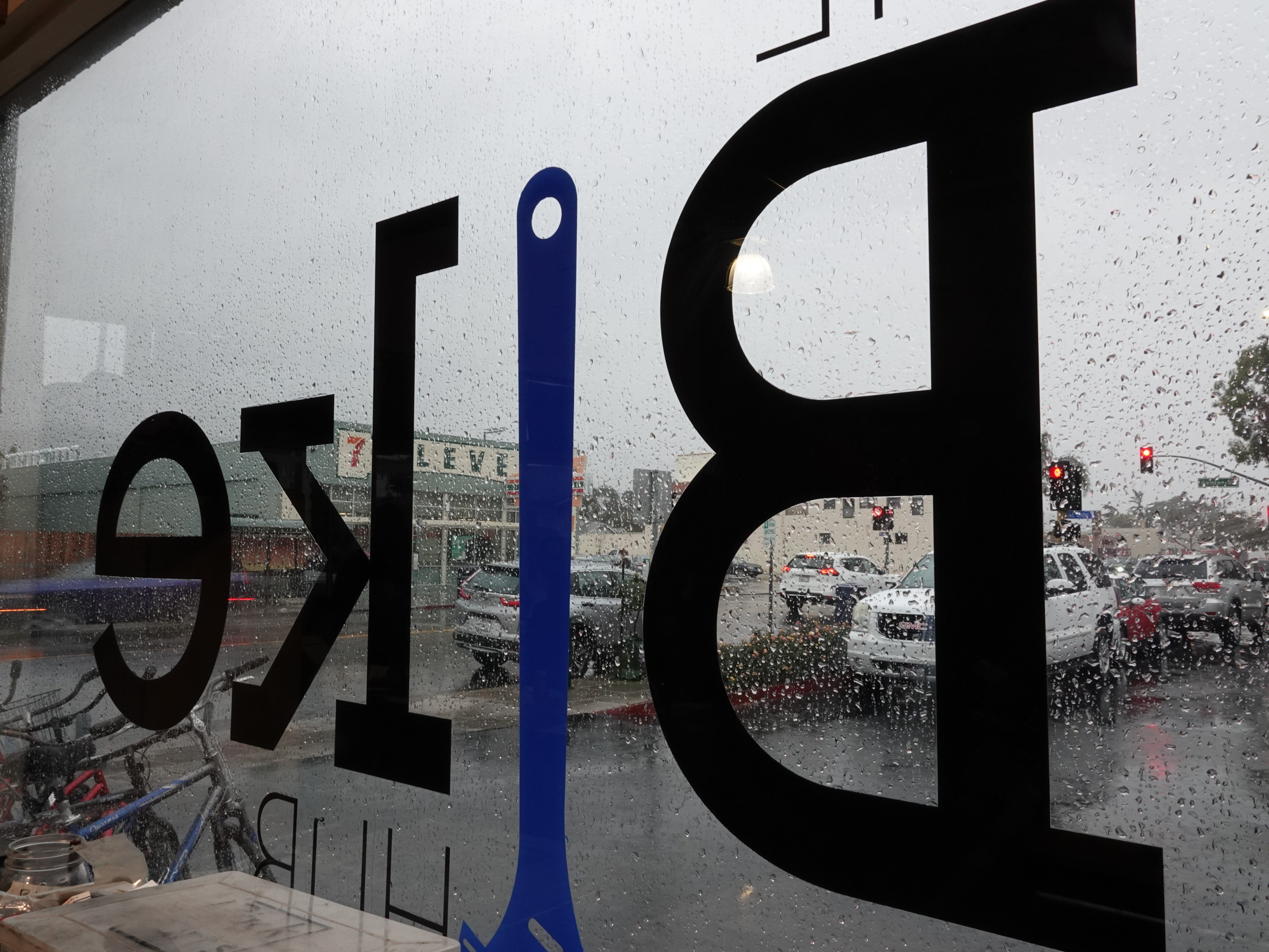 Rain fell on Ventura Avenue on Sunday outside the window of Ventura Bike HUB as shop staff and volunteers held a holiday bike giveaway for local children in need.