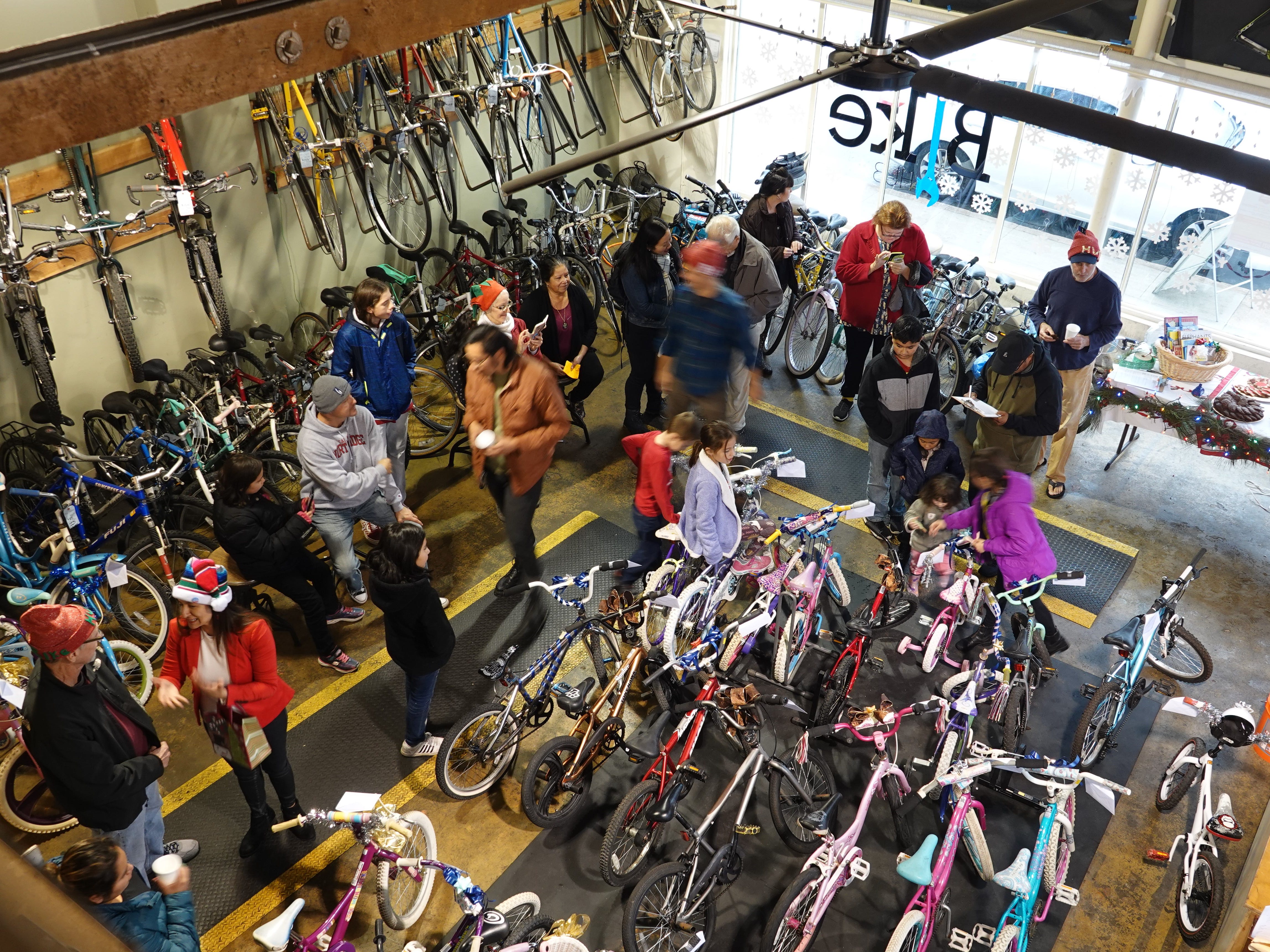 Children look over bicycles that will be part of a holiday giveaway at Ventura Bike HUB on Sunday afternoon. The nonprofit bike shop gave out more than 20 bikes to local kids in need.