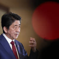 Prime Minister Shinzo Abe answers a question during a news conference in Chengdu, China, on Tuesday.