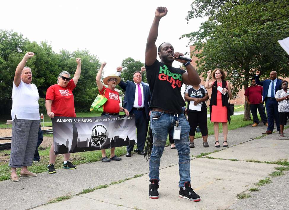 Shawn Floss Cooks, outreach worker with 518 SNUG, leads chants as anti-violence activists hold a rally at Third Avenue and Elizabeth Street near where a sleeping child was hit with a stray bullet last week on Tuesday, July 23, 2019 in Albany, N.Y. Albany 518 SNUG organized the gathering. (Lori Van Buren/Times Union)