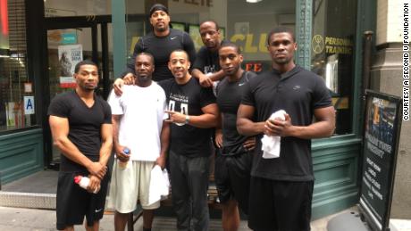 Hector Guadalupe, center, with graduates of his program in New York before Covid-19 closed gyms