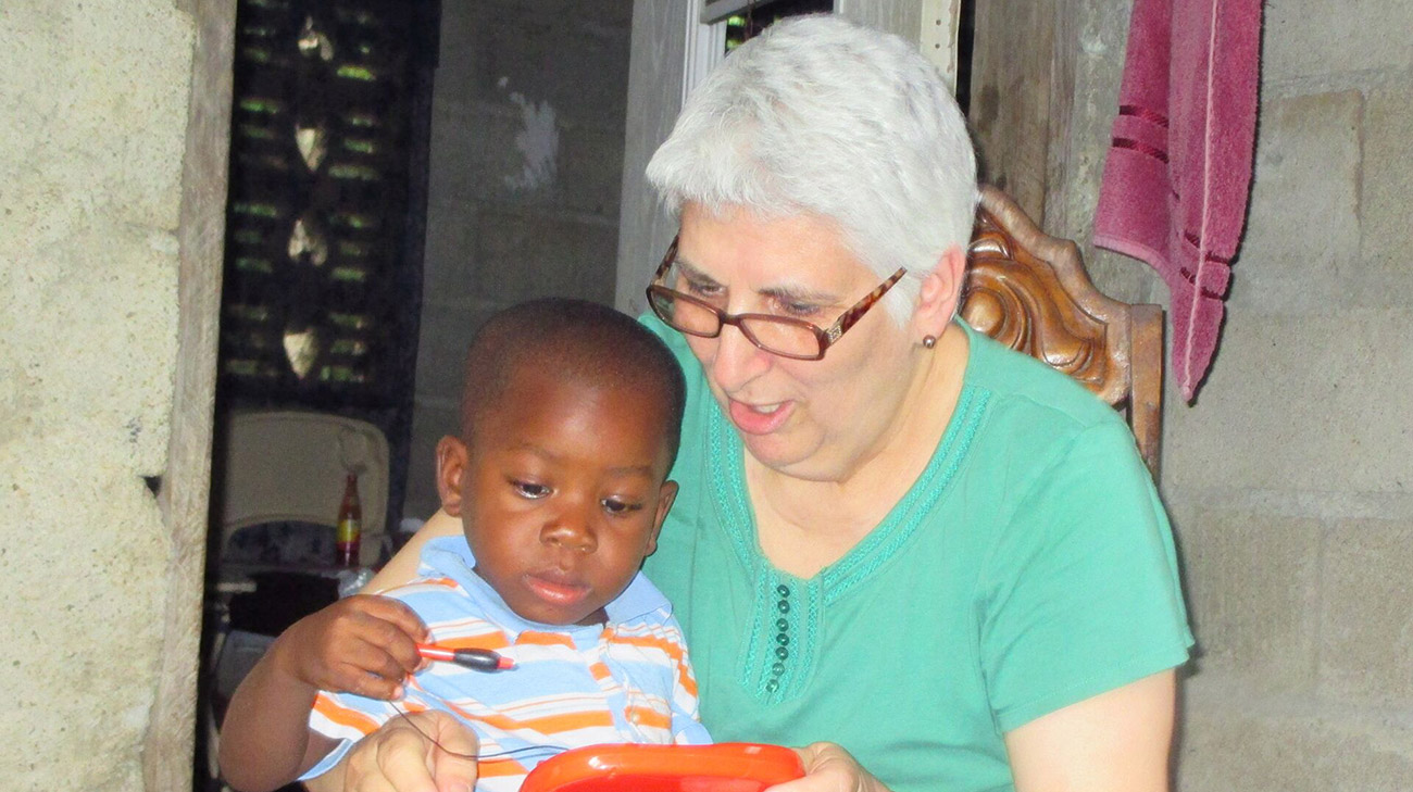 Jane with Sammy, 5, an orphan in Haiti she and her husband raised as one of their own. (Courtesy: Jane Dennington)