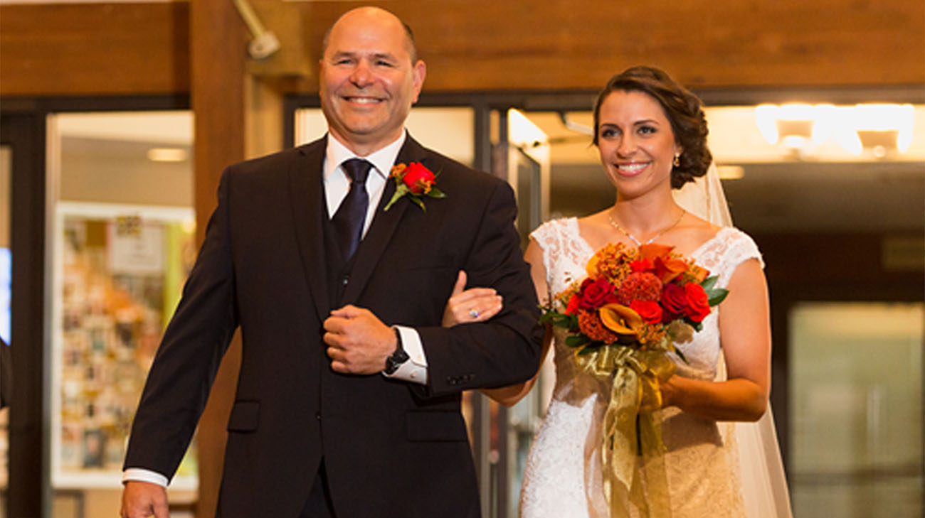 Jim and his daughter, Patti Kopasakis, as he walked her down the aisle on her wedding day. (Courtesy: Amber Rowe, Making the Moment)