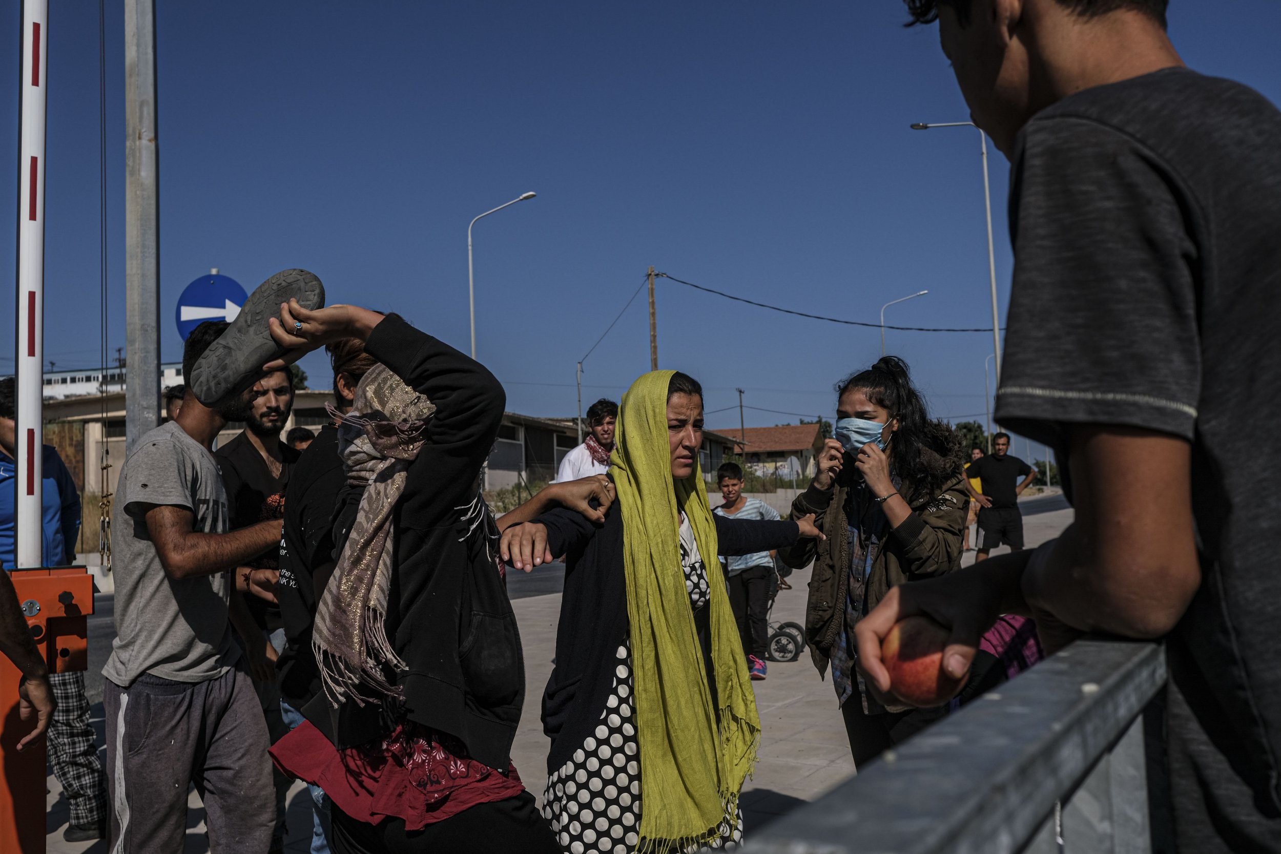 A group of asylum-seeking women can be seen standing.