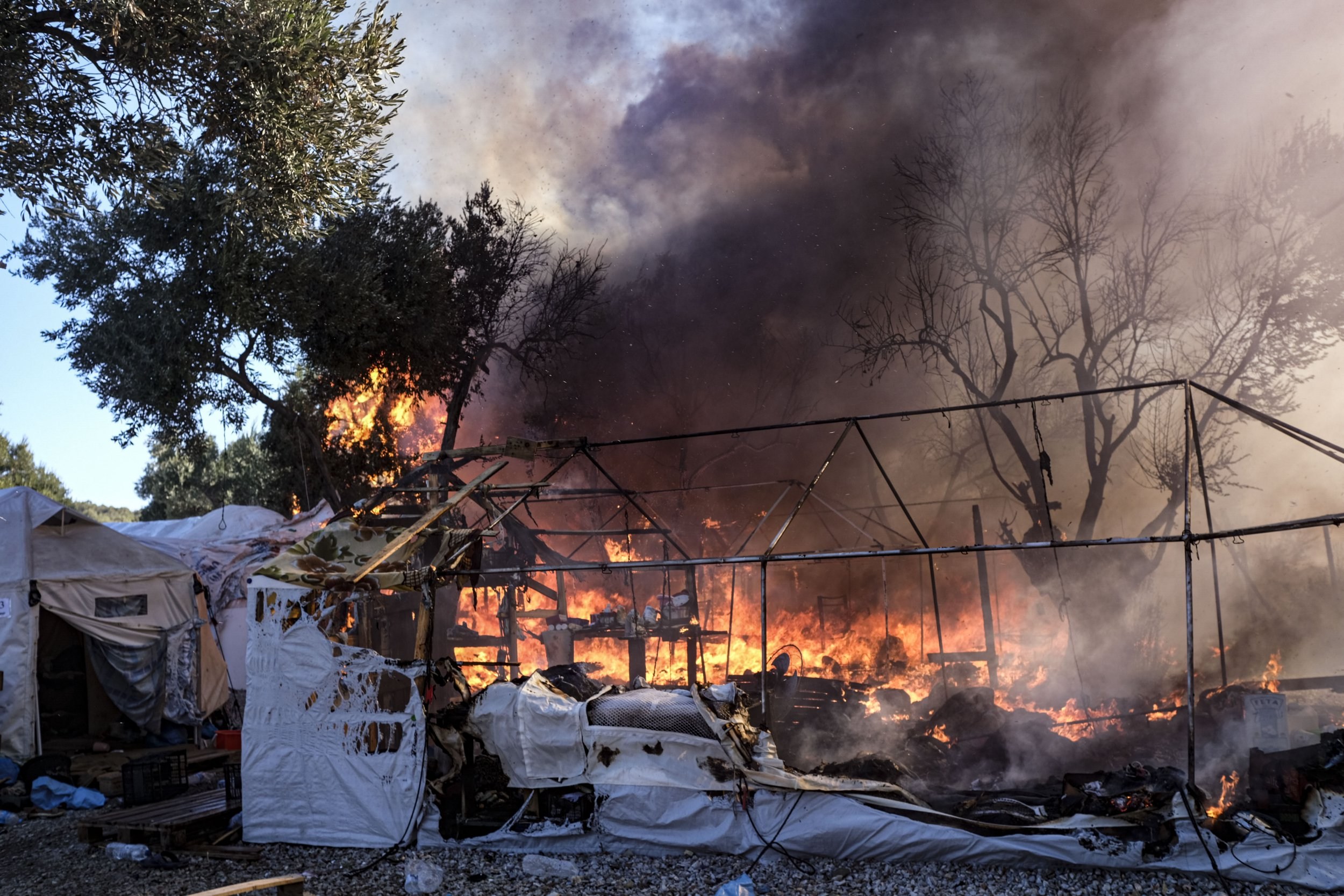 A raging fire can be seen burning its way through a shelter.