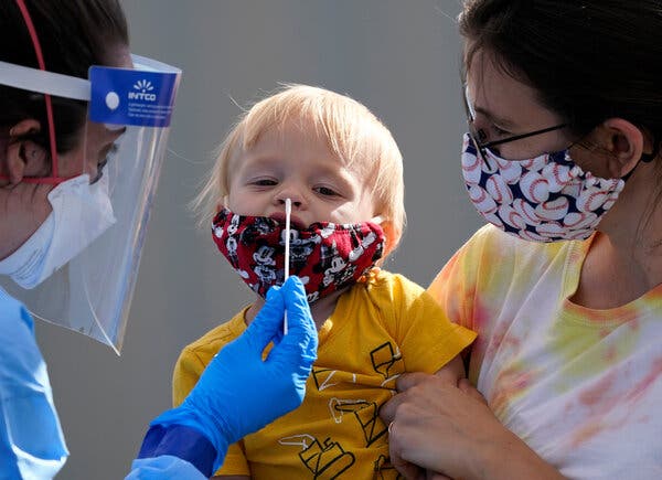 Many coronavirus testing sites do not screen children. One that does, outside Chief Sealth High School in Seattle, swabbed 1-year-old Quentin Brown late last month. 