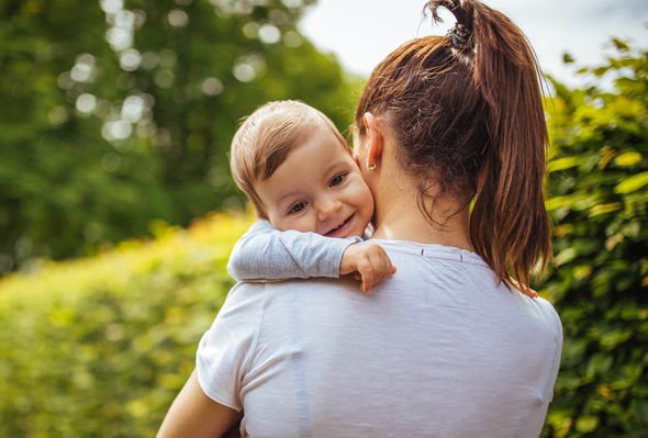 Mother holding little girl in arms 